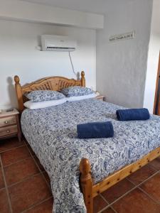 a bedroom with two beds with blue pillows on them at Casa Araflo in Cortijada Los Chorreros