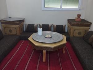 a living room with a table and two couches at Gite touristique bouknala in Abinane