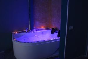 a bathroom with a tub with lights on it at U Baruni B&B in Messina