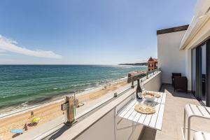 a balcony with a view of the beach at CoralMar Beachfront Apartment -Stunning Ocean Views -Algarve in Armação de Pêra