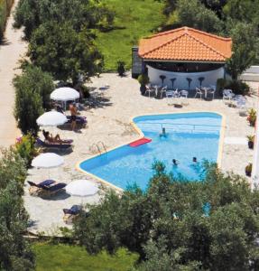an overhead view of a swimming pool with people in it at Artemis Bungalows in Stafylos