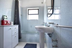 ein Badezimmer mit Waschbecken und Badewanne in der Unterkunft Vivenda Ribeiro - B in Lagos + 12 Fotos