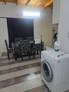 a kitchen with a table and a washing machine at Apartment for 2 people - Erezcano one in Adrogué +4 photos