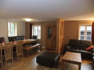 a living room with a couch and a table at HausJägerborn in Tanne