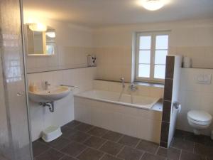 a bathroom with a tub and a sink and a toilet at HausJägerborn in Tanne