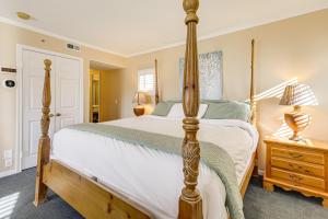 a bedroom with a four poster bed and a nightstand at 1 Mi to Mohegan Sun Studio with Golf Course Views in Norwich +16 photos