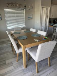 a wooden table with chairs and a dining room at Welcome to 246 Delmar Ave - Vacation Rental home in Fort Myers Beach