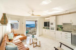 a living room with a couch and a table at Ocean View La Caleta in Adeje