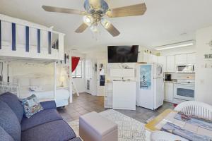 a living room with a couch and a ceiling fan at Paradise Cove in Panama City Beach