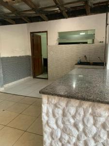 a kitchen with a counter top and a mirror at Casa in Cabo Frio