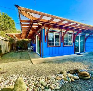 ein blaues Haus mit einem Holzdach in der Unterkunft Driftwood Cottage By The Ocean Beach & Redwoods in Smith River + 31 Fotos