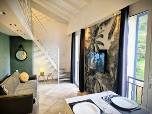 a living room with a couch and a table at La 34 Tiny House with sunny terrace in Menton +15 photos