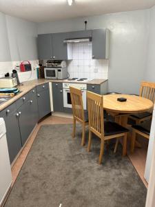 a kitchen with a wooden table and chairs at Symonds Yat West Holiday Cottage 8 WRC with views of Yat Rock in Symonds Yat +22 photos