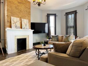 a living room with a couch and a fireplace at Chandler Studio Apartments in Evansville