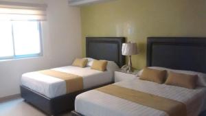 Säng eller sängar i ett rum på Hotel Tierra Roja