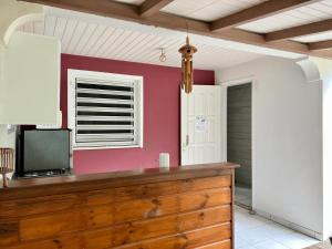 a kitchen with a wooden dresser and a window at Baz créole in Deshaies