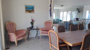 a dining room with a wooden table and chairs at Stone Crown Manor B&B in Diasstrand