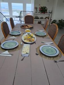 a long table with plates of food on it at Stone Crown Manor B&B in Diasstrand
