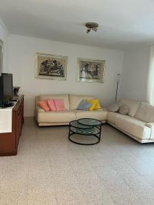 a living room with a couch and a table at El buen sol de la manga in La Manga del Mar Menor