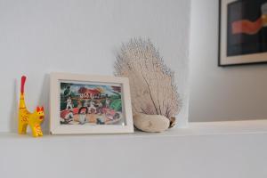 a shelf with a picture and some figurines on it at Caribe Rentals in San Juan