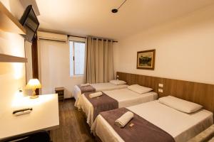 En eller flere senge i et værelse på Hotel Golden Star