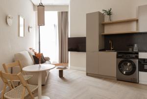 a kitchen with a washing machine and a table at MH Apartments Central Valencia in Valencia +13 photos