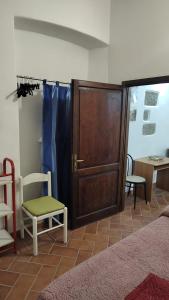 a living room with a wooden cabinet and a chair at Casa vacanze la torre in Umbertide