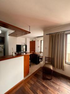 a kitchen and living room with a counter and a table at Departamento San Bernardo - Céntrico Salta in Salta