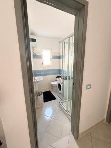 a bathroom with a toilet and a washing machine at Blue Oceano in Santa Maria