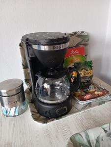a black coffee maker sitting on a shelf with food at Petit house Vrachati in Vrachati