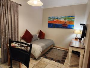 a bedroom with a bed and a desk and a painting at a Dam's View Accommodation in Queenstown +229 photos