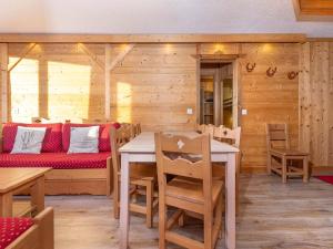 a dining room with a table and a couch at Charmant Appartement Rénové de 3 Chambres au Centre d'Avoriaz, Proche des Commerces et Pistes - FR-1-314-116 in Avoriaz +9 photos