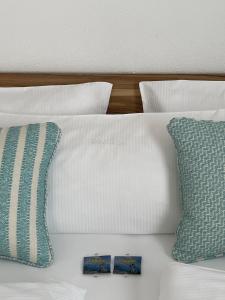 a white bed with two pillows on it at Die Trauminsel 2 in Lindau