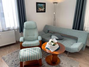 a living room with a couch and a chair at Die Trauminsel 2 in Lindau