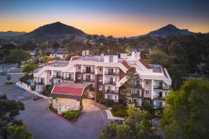 an aerial view of a building with mountains in the background at La Cuesta Inn, BW Signature Collection in San Luis Obispo