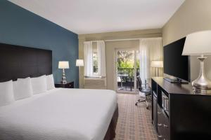 a bedroom with a large white bed and a desk at La Cuesta Inn, BW Signature Collection in San Luis Obispo +34 photos