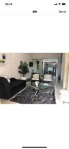 a living room with a couch and a table at Ahnaf Guest House in Sunggal