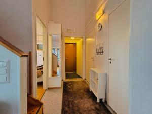 a room with a hallway with a mirror and a closet at Ruka Center Chalet 3B4 in Ruka