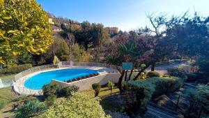 une vue aérienne d'une piscine dans un jardin dans l'établissement Charmant 2 pièces parc piscine, à Vence 3 autres photos