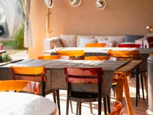 a group of tables and chairs in a restaurant at Villa Roswell Marrakech in Marrakech
