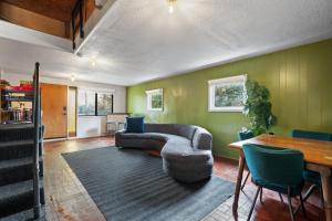 a living room with a couch and a table at Retro Getaway In Hazel Dell in Vancouver