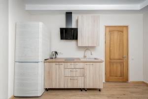a kitchen with a sink and a refrigerator at Atostogų būstas su jacuzzi in Klaipėda
