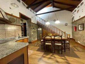 a kitchen with a table and chairs in a room at Casa La Candelaria - Moya in Moya