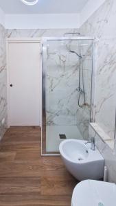 a white bathroom with a shower and a sink at Bardonecchia 3-room Apartment - Frejus Palace in Bardonecchia +47 photos