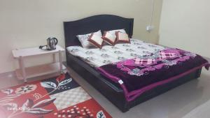 Ένα ή περισσότερα κρεβάτια σε δωμάτιο στο Moksha Home-Stay