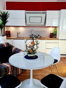 einen weißen Tisch mit einer Vase in der Küche in der Unterkunft Apartment Nordstern in Baabe