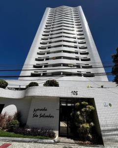 a tall white building with a large building at Apto 2/4 Centro Recife in Recife
