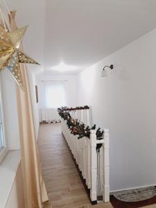 a hallway with christmas decorations and a star on the wall at Villa Nikšić in Otočac