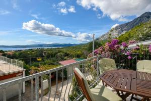 a balcony with a table and chairs and a view at Apartments Vila ViDa Orebić in Orebić