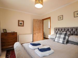 a bedroom with a bed with two pillows on it at Milltown House in Turriff